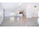 Open-concept living room with bright lighting, tile flooring, and seamless flow to the kitchen and entryway at 6512 Grosvenor Ln, Orlando, FL 32835