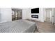 Spacious bedroom with a mounted TV over a fireplace, and sliding glass doors that provide ample natural light at 6512 Grosvenor Ln, Orlando, FL 32835
