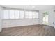 Bright sunroom with wood floors, large windows, and a door provide a cozy and inviting relaxation spot at 6512 Grosvenor Ln, Orlando, FL 32835
