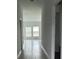 Hallway that leads to a living room with large windows at 680 Sand Pine Ln, Haines City, FL 33844