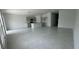 Open-concept living room and kitchen featuring tile flooring and neutral color palette at 680 Sand Pine Ln, Haines City, FL 33844