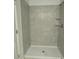 Walk-in shower with gray tiled walls and a built-in shelving at 680 Sand Pine Ln, Haines City, FL 33844