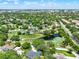 Aerial view of the community with tree lined streets and a pond at 6836 Bittersweet Ln, Orlando, FL 32819