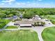 Bird's-eye view of the expansive clubhouse surrounded by golf greens and picturesque landscaping at 6836 Bittersweet Ln, Orlando, FL 32819