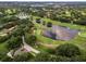 Wide aerial perspective of a lush golf course winding through a residential neighborhood with ponds and trees at 6836 Bittersweet Ln, Orlando, FL 32819