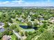 Aerial view of a neighborhood with a golf course and scenic ponds at 6836 Bittersweet Ln, Orlando, FL 32819