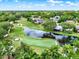 Aerial shot showcasing a home with stunning golf course and water views in a lush, green community at 6836 Bittersweet Ln, Orlando, FL 32819