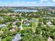 Neighborhood aerial view with verdant landscaping, community pond, and a golf course near a large lake at 6836 Bittersweet Ln, Orlando, FL 32819