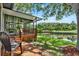 Scenic view from the wooden deck overlooking a serene pond and well-manicured golf course at 6836 Bittersweet Ln, Orlando, FL 32819
