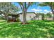 Spacious backyard features a screened lanai and a lush lawn at 6836 Bittersweet Ln, Orlando, FL 32819