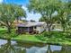 Scenic backyard with a pond view and relaxing screened-in porch at 6836 Bittersweet Ln, Orlando, FL 32819