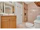 The bathroom features a wooden vanity with a sink and a stand-up shower with custom tile at 6836 Bittersweet Ln, Orlando, FL 32819