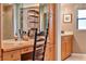 A well-lit bathroom vanity area with storage cabinets, counter space, and mirrored wall at 6836 Bittersweet Ln, Orlando, FL 32819