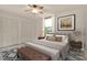 Neutral bedroom with a queen bed, two closets and a large picture window at 6836 Bittersweet Ln, Orlando, FL 32819