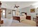 Large primary bedroom featuring a king size bed, ceiling fan, carpeted floor, and lots of natural light at 6836 Bittersweet Ln, Orlando, FL 32819