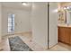 Foyer featuring neutral tile flooring, an entry door, and access to a bathroom at 6836 Bittersweet Ln, Orlando, FL 32819