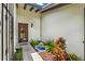 Inviting home entrance with a decorative water feature, garden, and stylish door at 6836 Bittersweet Ln, Orlando, FL 32819