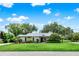 Charming single-story home featuring lush landscaping and a well-maintained front lawn at 6836 Bittersweet Ln, Orlando, FL 32819
