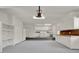 Spacious garage with white cabinets, plenty of storage space and a utility sink and washer and dryer at 6836 Bittersweet Ln, Orlando, FL 32819