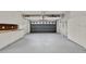 Organized garage with white cabinets and a work bench and ample storage space at 6836 Bittersweet Ln, Orlando, FL 32819