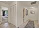 Hallway featuring neutral tile flooring, a patterned rug, and access to a bedroom and bathroom at 6836 Bittersweet Ln, Orlando, FL 32819