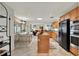 Open-concept kitchen featuring an island, wooden cabinets, and stainless steel appliances at 6836 Bittersweet Ln, Orlando, FL 32819