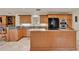 Well-equipped kitchen featuring an island, granite countertops, and wooden cabinetry at 6836 Bittersweet Ln, Orlando, FL 32819