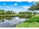 View of pond, golf course and homes; water reflects clouds in sky at 6836 Bittersweet Ln, Orlando, FL 32819