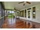 Spacious screened-in porch with hardwood floors, ceiling fans and views of the backyard at 6836 Bittersweet Ln, Orlando, FL 32819