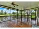 Spacious screened porch features a wooden floor, ceiling fans, and views of the golf course and pond at 6836 Bittersweet Ln, Orlando, FL 32819