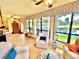 Well-lit sunroom featuring tile flooring, ceiling fans and comfortable chairs around a center table at 6836 Bittersweet Ln, Orlando, FL 32819