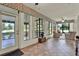 Bright sunroom featuring a tiled floor, ceiling fans and lots of windows to enjoy views of the garden at 6836 Bittersweet Ln, Orlando, FL 32819