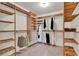Large walk-in closet with custom wood shelving for optimal storage and organization at 6836 Bittersweet Ln, Orlando, FL 32819