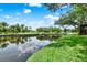 Picturesque water view featuring a calm pond reflecting the sky and surrounding greenery at 6836 Bittersweet Ln, Orlando, FL 32819