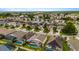 Expansive aerial view of a residential neighborhood featuring lush green lawns and screened-in pools at 8152 Fan Palm Way, Kissimmee, FL 34747