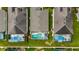 Aerial shot featuring screen-enclosed pools in backyards and well-maintained lawns in a residential community at 8152 Fan Palm Way, Kissimmee, FL 34747