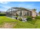 Enjoy the outdoor enclosed pool with a jacuzzi, chairs, table, and a lovely garden along the side for relaxation at 8152 Fan Palm Way, Kissimmee, FL 34747