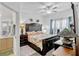 Spacious bedroom featuring a decorative headboard, floral bedding, and natural light at 8152 Fan Palm Way, Kissimmee, FL 34747