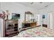Bright bedroom featuring floral bedding, ceiling fan, and a view to the yard at 8152 Fan Palm Way, Kissimmee, FL 34747