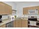 Efficient kitchen with stainless steel appliances, light cabinets, and dual sink at 8152 Fan Palm Way, Kissimmee, FL 34747