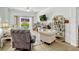 Cozy living room with natural light, tile flooring, and a view to the backyard pool at 8152 Fan Palm Way, Kissimmee, FL 34747