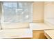 Bright bathroom featuring a large tub, vanity space, and a window for natural light at 8206 Gemstone Ct, Orlando, FL 32836