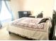 Bedroom featuring a comfy bed with decorated cover, plus dresser at 8206 Gemstone Ct, Orlando, FL 32836