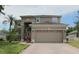 Charming two-story home with a spacious two-car garage and professionally landscaped yard at 8206 Gemstone Ct, Orlando, FL 32836