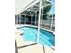 Outdoor pool with screen enclosure and patio at 8206 Gemstone Ct, Orlando, FL 32836