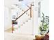 Bright staircase with white steps and wood railing at 8206 Gemstone Ct, Orlando, FL 32836