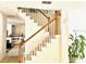 Well-lit staircase with wooden railings, leading to the upper floor of the home at 8206 Gemstone Ct, Orlando, FL 32836