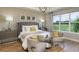 Serene main bedroom with large windows, neutral decor, and ample natural light and ensuite bath at 854 Junonia Blvd, New Smyrna Beach, FL 32168