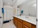 Bathroom featuring a single sink vanity with wood cabinets and a tiled shower at 8108 Via Bella Notte, Orlando, FL 32836