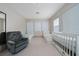Spacious bedroom with two single beds, a crib, and comfortable seating at 8108 Via Bella Notte, Orlando, FL 32836